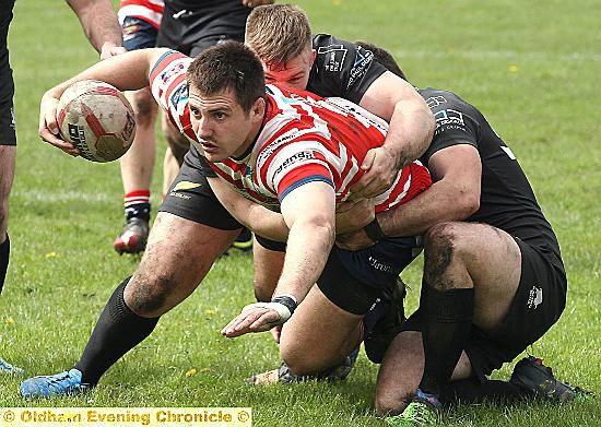 ACTION STATIONS: Oldham’s Phil Joy tries desperately to get to the Gloucester try-line. 