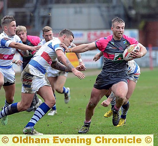 ON THE RUN: Roughyeds star Adam Clay takes on the Rochdale Hornets defence.
