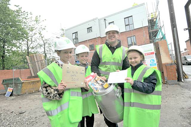 Pupils from Propps Hall Primary School plant Time Capsule at Victoria St Flats Failsworth

L to R Molly Barlow -Moore. Ethan Conroy, Edward Jackson Director, Esther Paddison.