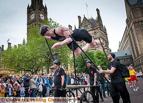PROUD: Olympic hero Henry Taylor “swims” past Manchester Town Hall. The gold medallist was the focus of Oldham’s contribution to the Manchester Day parade
