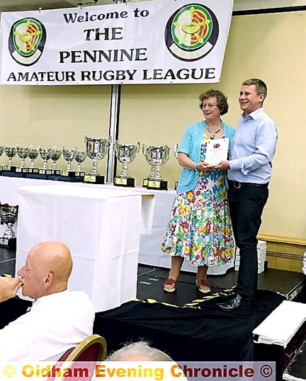 Andy Mellor receives his recognition from Oldham League vice-chairperson Anita Halliwell.
