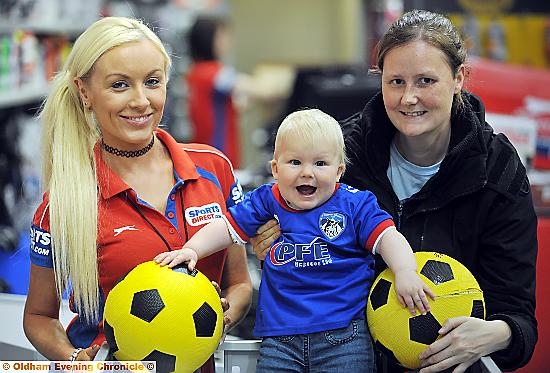 COMIC STRIP: Athletic’s new home kit for next season went on sale at the Sports Direct store in town yesterday - and there to snap up a shirt for smiling 10-month-old Emily Finnegan was mum Sarah, pictured with sales assistant Natalie McAiney.