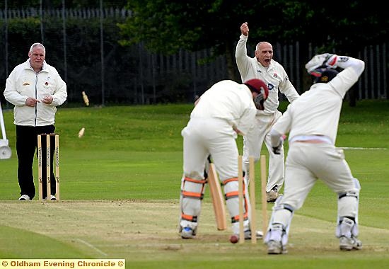 GOTCHA: Crompton’s Mel Whittle celebrates after bowling Royton’s Tony Walsh for two. Picture by TIM BRADLEY.