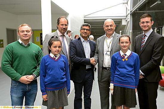 ALL smiles . . . (back, from left) Mike Hamilton, of Commando Joe’s; William Lees-Jones, managing director of JW Lees Brewery; Simon Arora, from B&M Bargains; Mahdlo chairman Terry Flanagan and Councillor Jim McMahon. Front:Alisha O’Connor and Lucy Haynes from St Thomas’ School, Leesfield