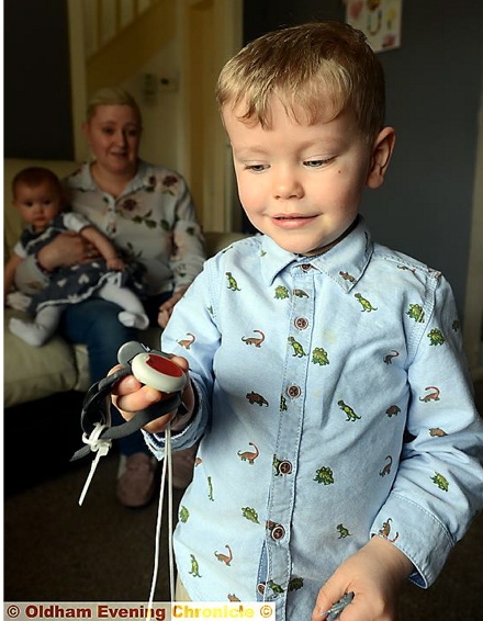 LITTLE life saver... Jack Griffin (3) with the emergency response button he uses to get help
