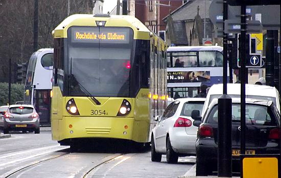 Two trams were halted for 20 minutes when the driver of a car refused to move.