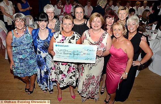 A YEAR of fundraising . . . Helen Haigh (front, left) presents £12,000 cheque to Maria Bramley, consultant breast surgeon at Victoria Breast Care Unit