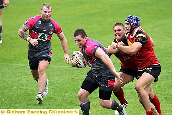 ON THE BURST: Oldham’s Adam Files carries the fight to the Crusaders.