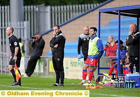 FOOD FOR THOUGHT . . . Athletic boss Darren Kelly views last night’s action, while trialists Jimmy Keohane (yellow top) and Jack Mmaee (yellow boots) look on. 