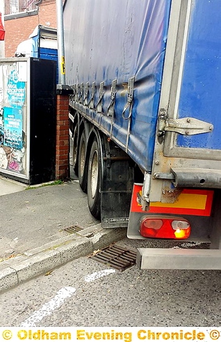 A lorry mounts the pavement and comes within centimetres of hitting the wall at Chadderton News.