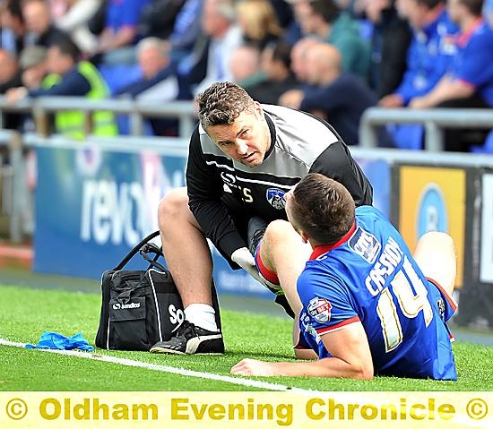 BREAKING POINT . . Athletic forward Jake Cassidy is attended to by physio Craig Schofield.