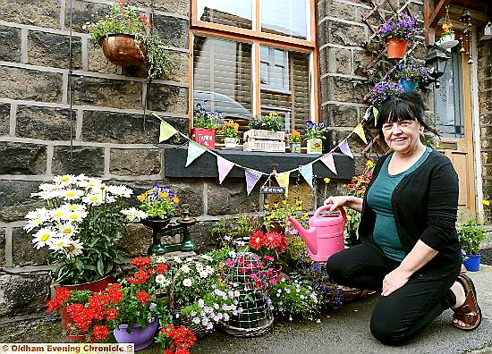 KEEPING on top of it . . . Paula Bateson waters her plants as the container garden winner
