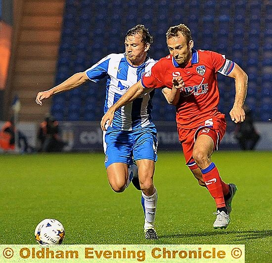 RUNNING GAME . . . Athletic skipper Liam Kelly (right) tries to get ahead of his Colchester opponent in last night’s game. 
