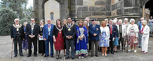 ALL together now . . . Oldham Mayor, Councillor Ateeque Ur-Rehman and his wife, Mayoress Yasmin Toor, next to Captain Frank le Messurier and others who attended the 70th anniversary Guernsey evacuees service