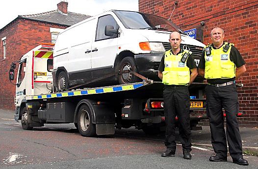 SEIZED: neighbourhood enforcement officers David Scanlon and Mark Greenhalgh with the van