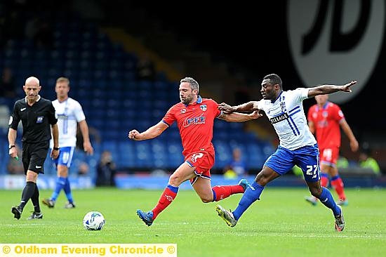 RUNNING BATTLE . . . David Dunn shows power to go alongside his finesse during this midfield duel.