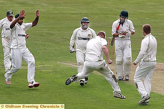 CELEBRATION . . . for Royton’s players following the wicket of Norden skipper Simon North.
