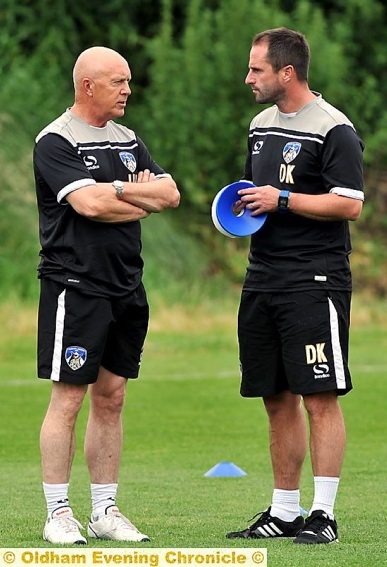 THINK TANK . . . Jim Harvey (left) talks to manager Darren Kelly before his exit.