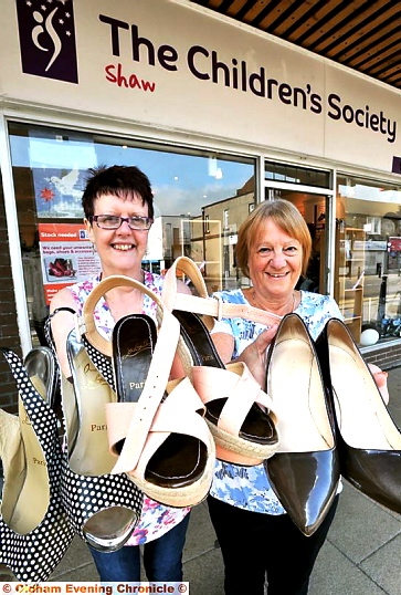 DESIGNER bargains . . . shop manager Carol Forshaw (left) and volunteer Kathryn Frankland with the shoes