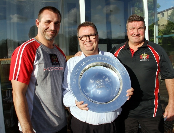 SHOWING THE SHIELD: Scott Naylor (left) with his assistant Lee Spencer (right) and Oldham chairman Chris Hamilton.