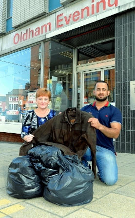 Smko Mahmod with Tracey Holmes, from the Oldham Chronicle, making a donation of warm clothing from the newspaper’s staff to take to Calais