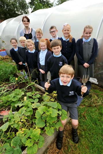 GREEN-fingered: members of the Higher Failsworth Primary gardening club with Claire Yates.
