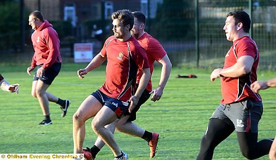 FIT FOR THE FIGHT . . . Oldham players are put through their paces at training last night.