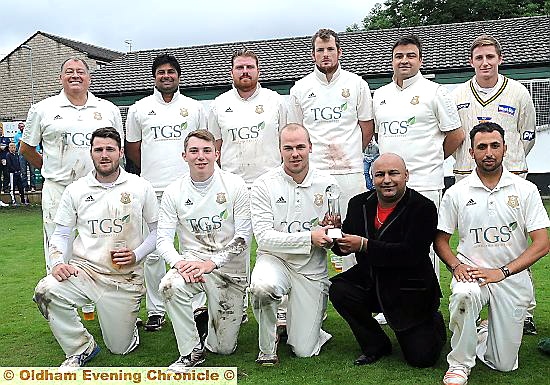 IT’S YOURS: surrounded by his team-mates, Saddleworth captain Brian Lord accepts the Twenty20 trophy from sponsor Mohammed Naveed, of Pro-Elite Sports.