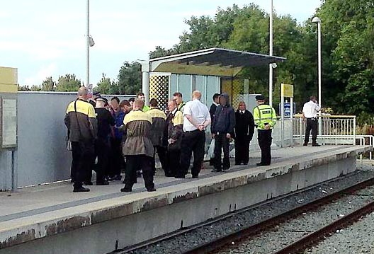 SWOOP . . . Metrolink staff, flanked by police, issue fines to fare dodgers at the Failsworth stop
