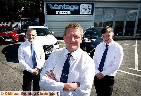 IN the driving seat . . . (from left) David A Cunningham, Vantage Oldham centre principal, with staff Andy McGevor and Simon Barlow