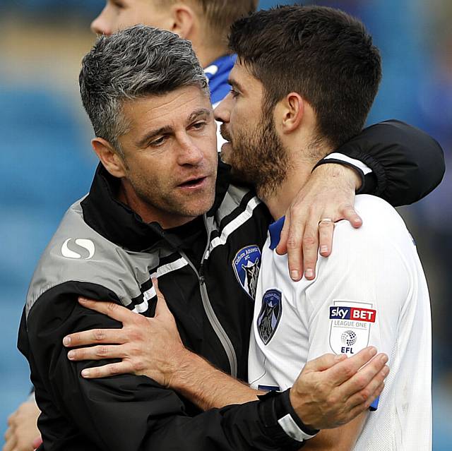 Oldham match winner Ryan Flynn (R) gets a hug from his manager Stephen Robinson at the end of the League One game between Gillingham and Oldham Athletic at the KRBS Priestfield Stadium, Gillingham, on Sat Oct 8, 2016