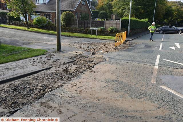 Damage caused by burst water main on Manchester Road, Greenfield at the junction with Dacres Road.
