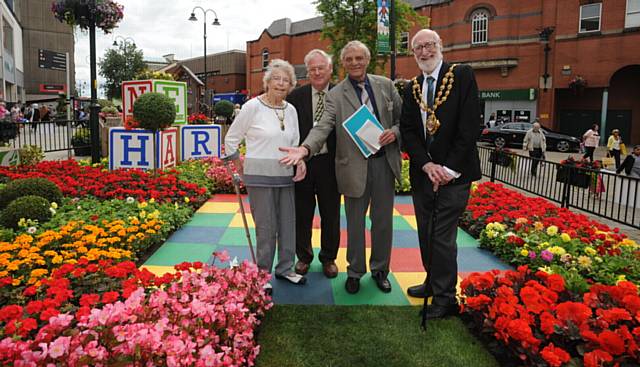LOOK how we've grown . . . Oldham Mayor and Mayoress Derek Heffernan with judges (centre) Brian Whalley and Malcolm Ewbank
