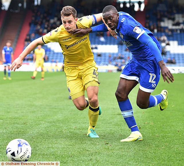 RUNNING GAME . . . Athletic front man Freddie Ladapo brushes aside a Bristol Rovers opponent
