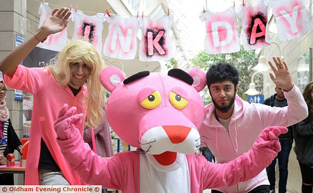 Pink Day at Oldham Sixth Form College. (l-r) Ibrahim Chishti, Pink Panther and Tameem Rahman