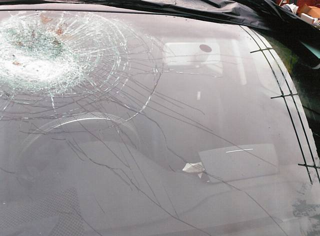 DAMAGED . . . a brick was hurled at the taxi's windscreen