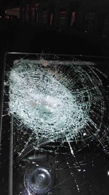 DAMAGED . . . a brick was hurled at the taxi's windscreen