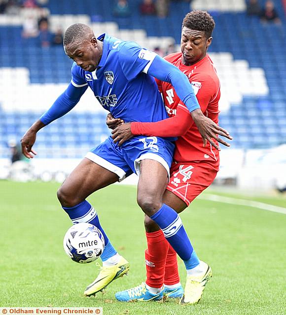 CLOSE CONTACT . . . Freddie Ladapo (left) shields the ball
