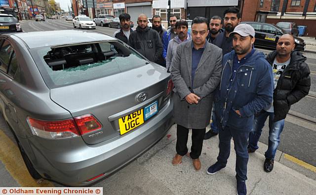 UNDER attack . . . (front, from left) Mohammed Akbar (owner Oldham and Bardsley Cars) with Khizar Islam and fellow drivers