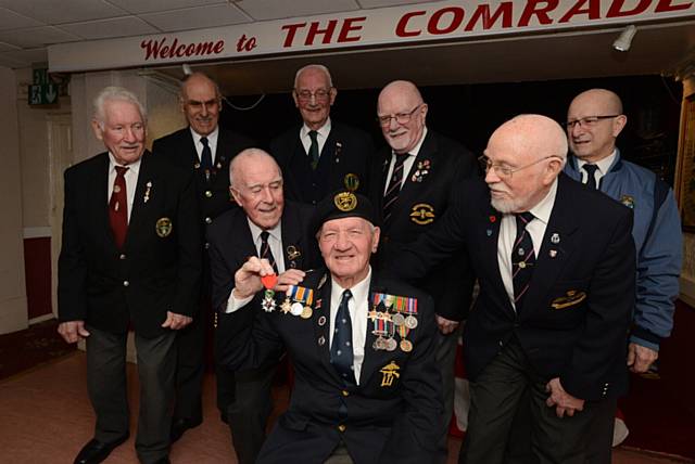 92-year-old Ernie Mayall (seated, centre), a member of the Oldham Royal Naval Association, was awarded the Legion D'Honneur for his role in the D-Day landings during World War II. Pic at Shaw Comrades' Club with fellow RNA members left to right, Eddie Smith, David Browne, Harry Oakley, Vinnie Gartside, Matt Gilmore (chairman), Pongo Gordon, Ricky Smith.