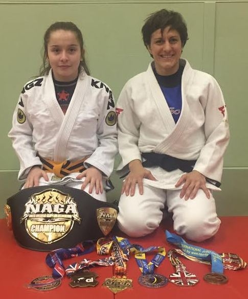 A NAME TO REMEMBER . . . 12-year-old prospect Libby Genge is pictured with her coach Sophie Cox and their judo and Brazilian jiu jitsu medals