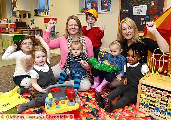 OUTSTANDING news . . . Simon’s House Nursery celebration with manager Susie Mortin (left) and Victoria Burke with some of the children
