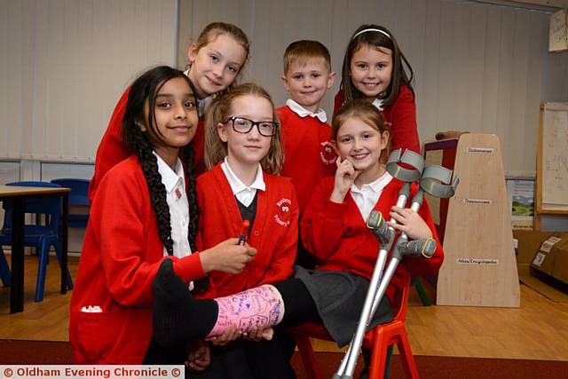 Rushcroft Primary School, Shaw. Jessica Baxter (8) with her friends back at school after accident. (l-r) Ifsah Bibi (9) signs her cast, Lily Mae Walsh (8), Ruby Brown (8), Jesica's brother Callum Baxter (6), Jessica Baxter (8) and Molly Williams (8).