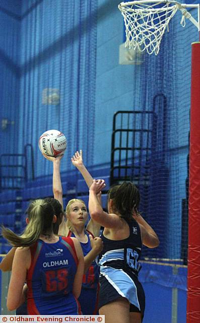 EYES ON THE NET . . . Under pressure from defenders, Oldham's Kathryn Turner lines up an attempt against The Downs.