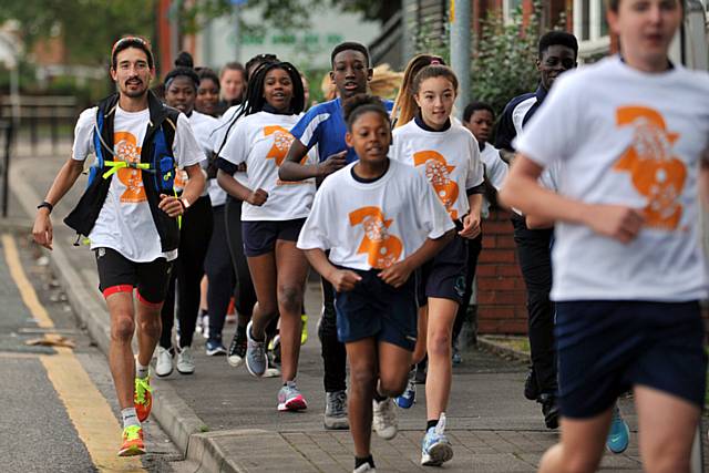 Adam Holland and some of the Oasis Academy pupils who joined his run in Oldham
