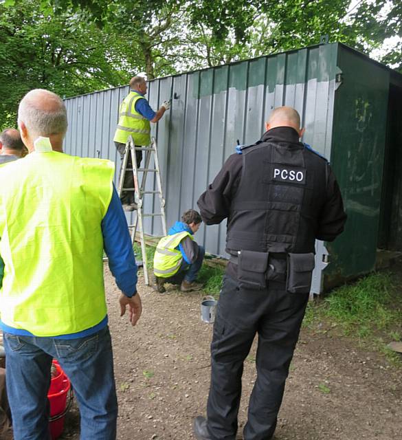 Volunteers and local PCSOs hepled to paint the cabins.