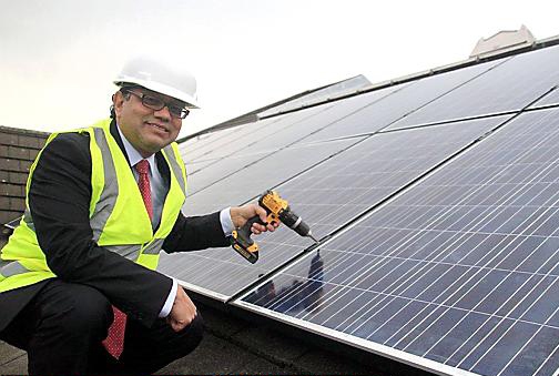 Market goes green . . . Councillor Abdul Jabbar with the solar panels that will save £9,000 a year in Tommyfield electricity bills