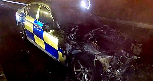 LUCKY escape . . . the officer managed to get out of this patrol car when it went up in flames