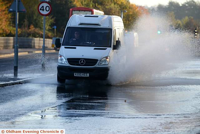 Water burst on Hollinwood Avenue next to the Victoria Hotel.
