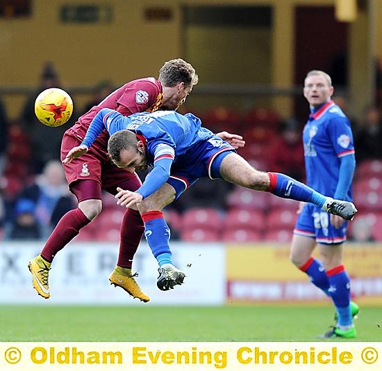 MID-AIR COLLISION . . . Liam Kelly is heading for a bumpy fall as Brian Wilson looks on.